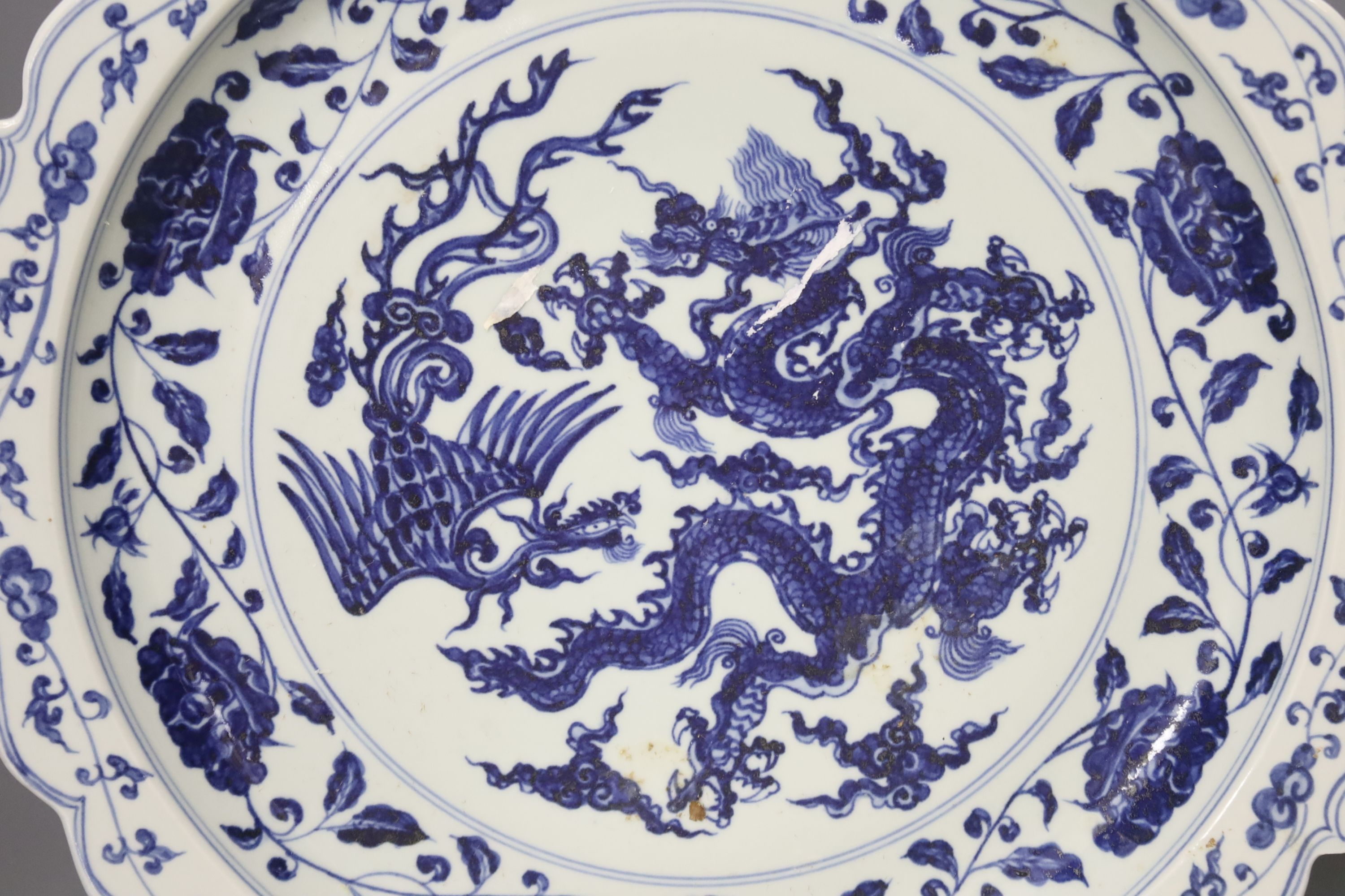 A Chinese blue and white Ming style dragon and phoenix dish, diameter 40cm